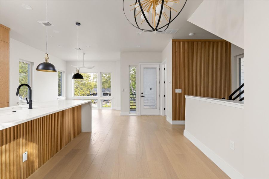 Clean lines and warm wood accents define this bright, open-concept living and kitchen area.