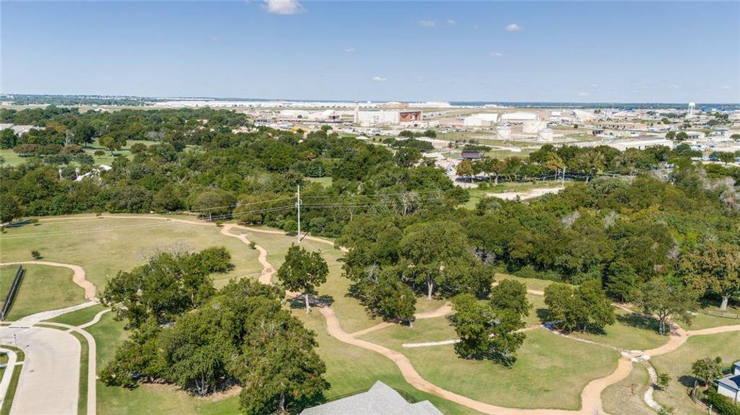 Aerial overview of property's location featuring a tree filled landscape