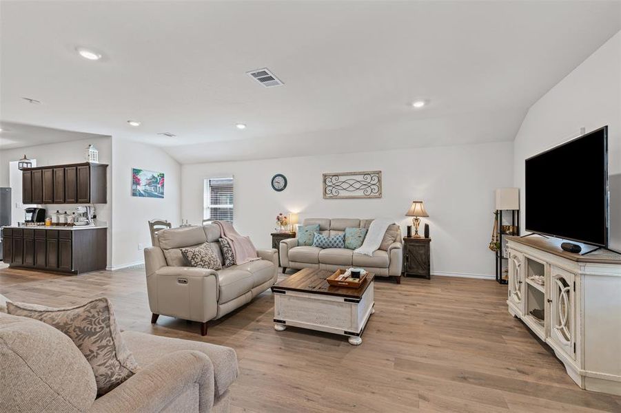 Spacious open-layout living area with modern recessed lighting and seamless flow into the kitchen and dining spaces. Spacious open-layout living area with modern recessed lighting and seamless flow into the kitchen and dining spaces.