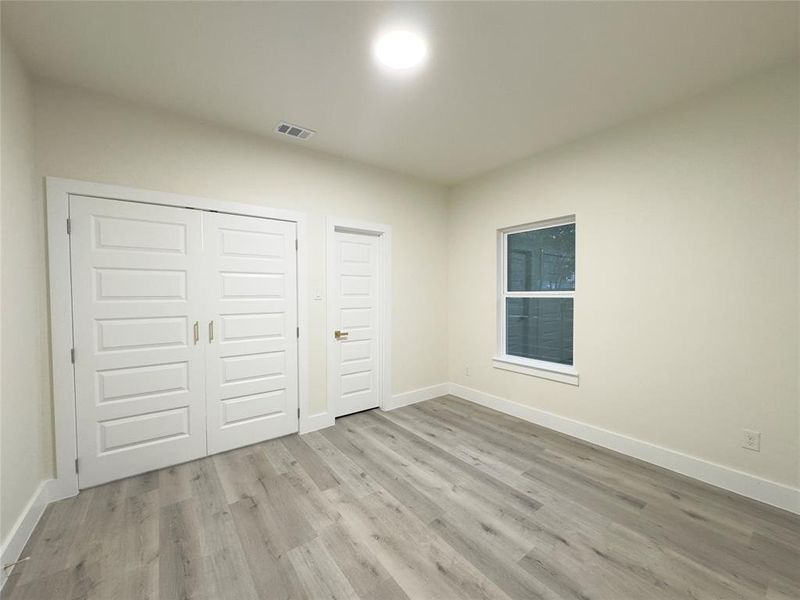 Unfurnished bedroom with light wood-type flooring