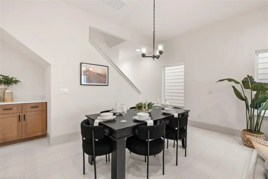 Dining room with soaring ceilings and pendant chandelier Dining room with soaring ceilings and pendant chandelier