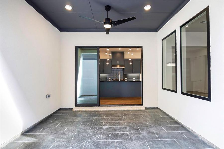 View of exterior entry with a sink and a ceiling fan