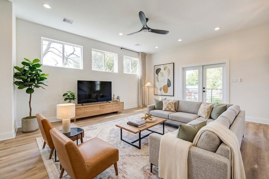 Bright and inviting living room with large operable clerestory windows, soft modern fixtures. Large sliding door that opens to the covered balcony for indoor-outdoor living and entertainment. Bright and inviting living room with large operable clerestory windows, soft modern fixtures. Large sliding door that opens to the covered balcony for indoor-outdoor living and entertainment.
