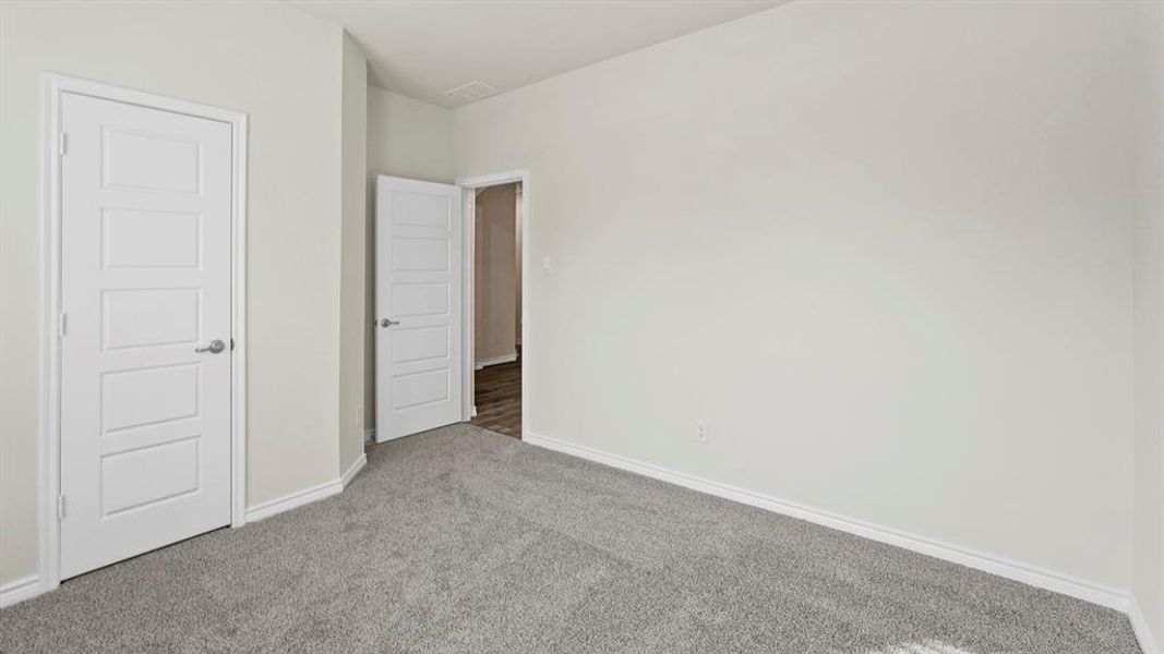 Unfurnished bedroom with carpet floors and baseboards Unfurnished bedroom with carpet floors and baseboards
