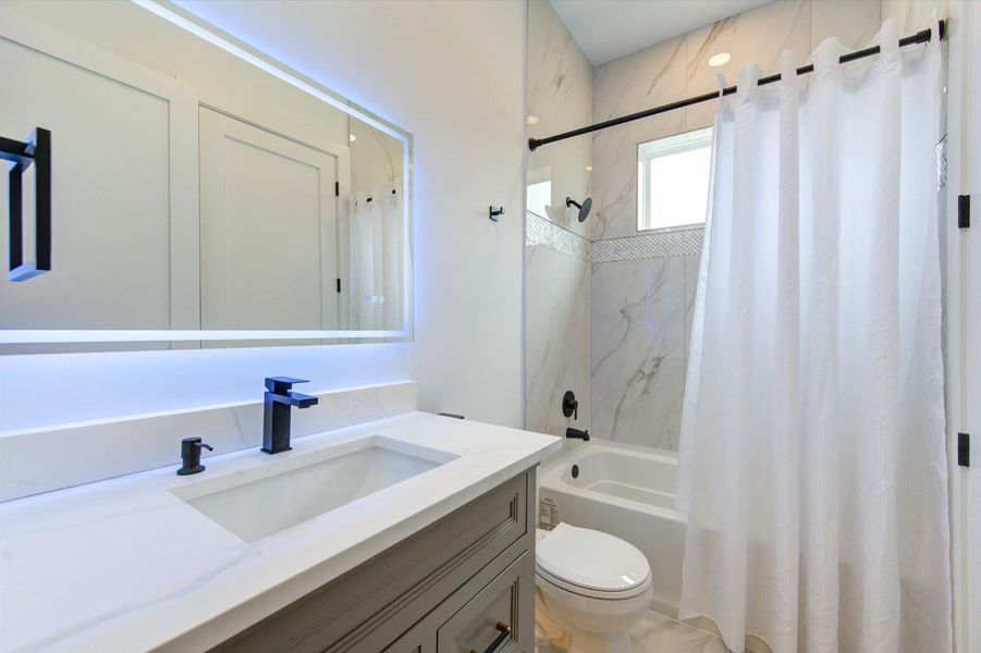 Bathroom #3 on 2nd flooor. Custom floating vanity with LED light under with motion detector are all standard.