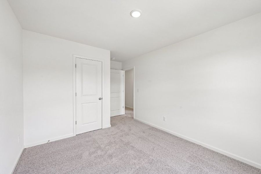 A hallway with white doors. A hallway with white doors.