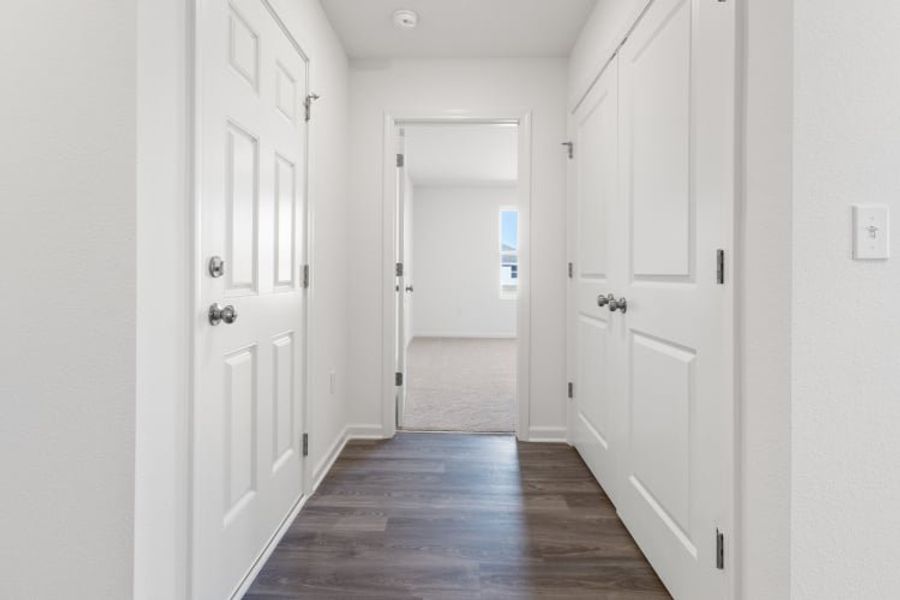 A hallway with white doors.