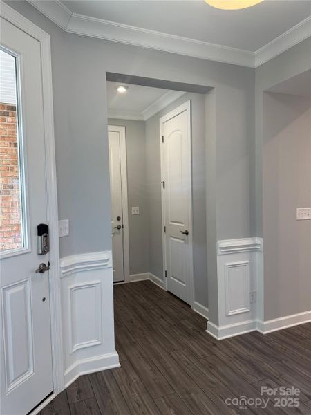 Hall with powder room leading to 2 car garage