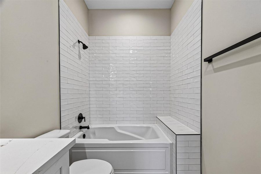 Secondary bathroom featuring a spacious combination soaking tub and shower. Secondary bathroom featuring a spacious combination soaking tub and shower.