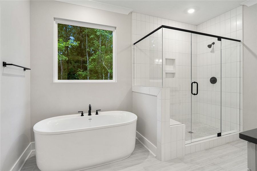 Unwind in the primary bath, featuring a generous s Unwind in the primary bath, featuring a generous s