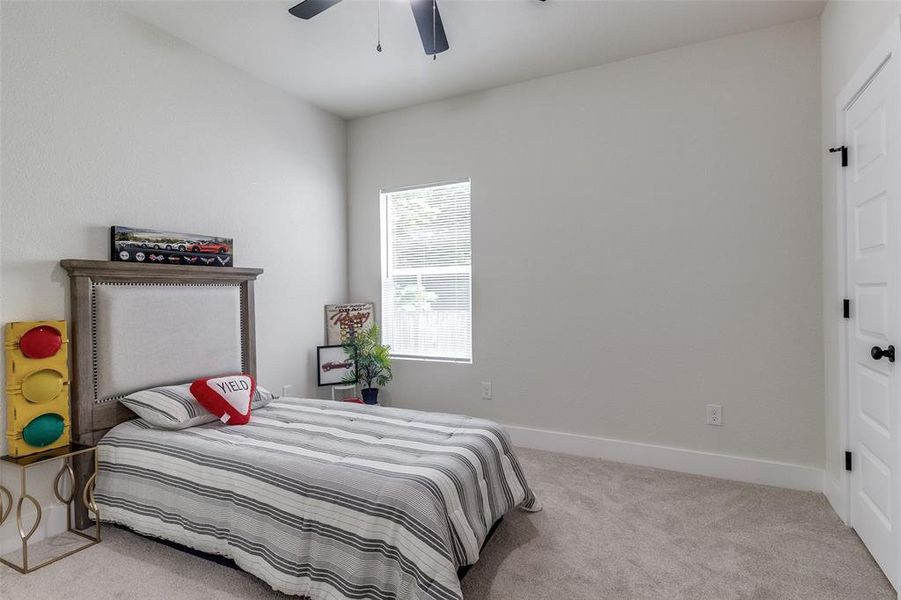 Carpeted bedroom with ceiling fan