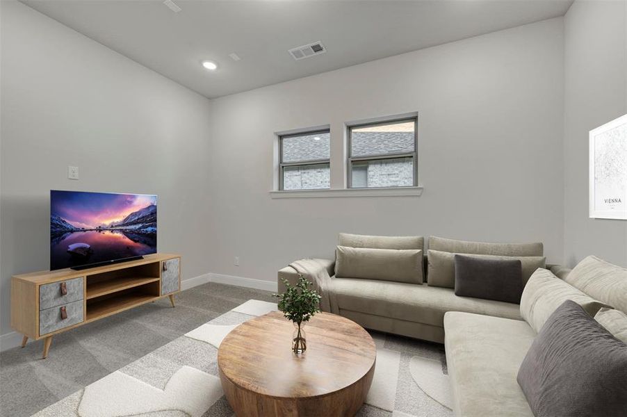 Carpeted living room featuring baseboards and recessed lighting
