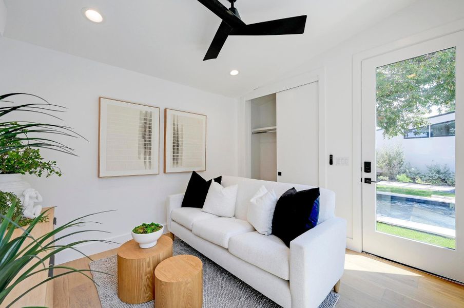 Living room featuring wood finished floors, recessed lighting, and a ceiling fan