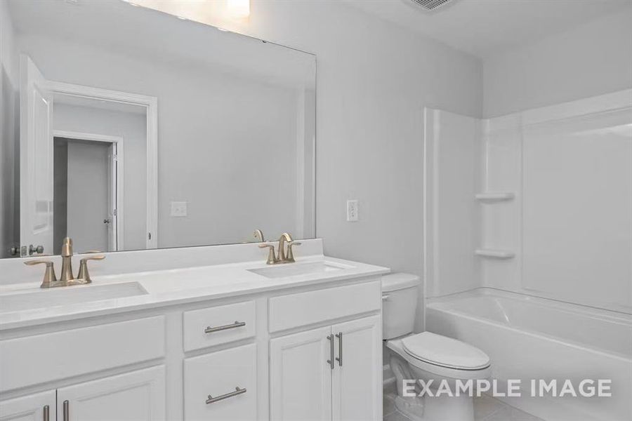 Full bathroom featuring vanity, toilet, and shower / bath combination