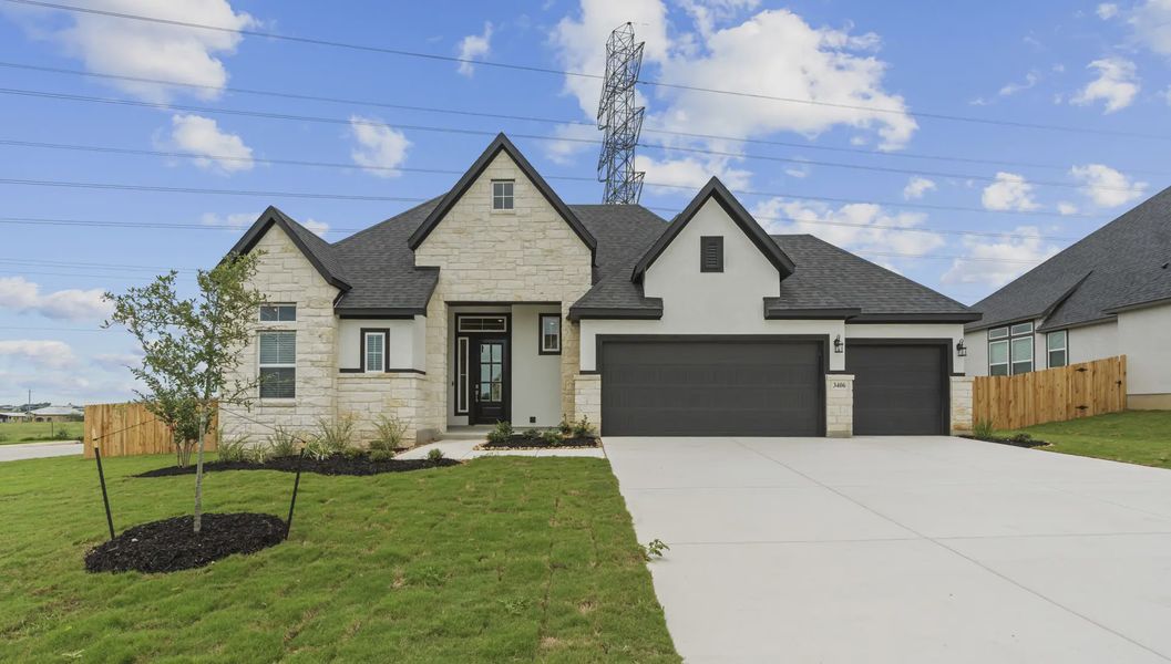 Front exterior of a new home in The Reserve at Potranco Oaks, Castroville, TX, highlighting curb appeal (Image 1). Front exterior of a new home in The Reserve at Potranco Oaks, Castroville, TX, highlighting curb appeal (Image 1).