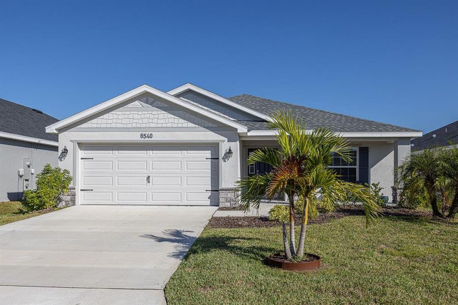 Front exterior of a new home in , Parrish, FL, highlighting curb appeal (Image 18).