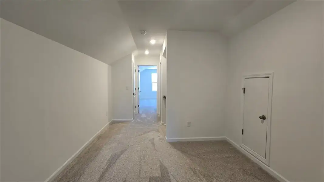 Angled ceilings and soft plush carpeting define th