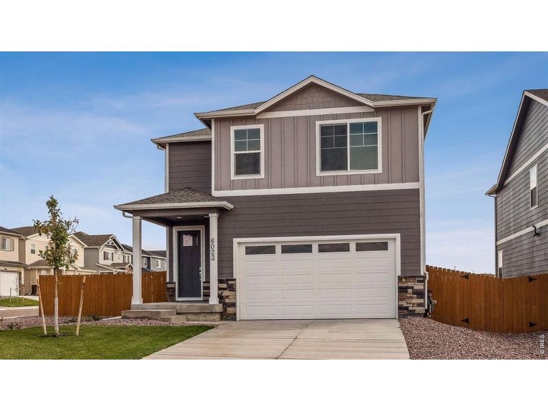 Front exterior of a new home in Prairie Song, Windsor, CO, highlighting curb appeal (Image 1). Front exterior of a new home in Prairie Song, Windsor, CO, highlighting curb appeal (Image 1).