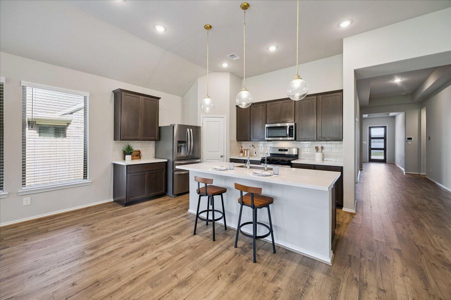 Speaking of kitchens, this one will bring out your inner chef. This gourmet kitchen features an oversized island, quartz counters, and stainless steel steel appliances.