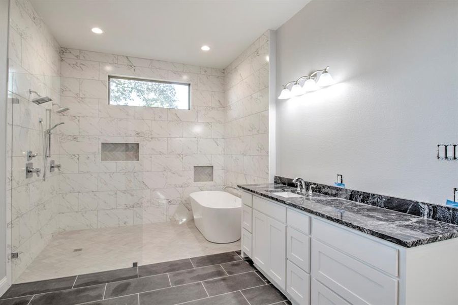 Bathroom featuring vanity, shower with separate bathtub, and tile patterned flooring