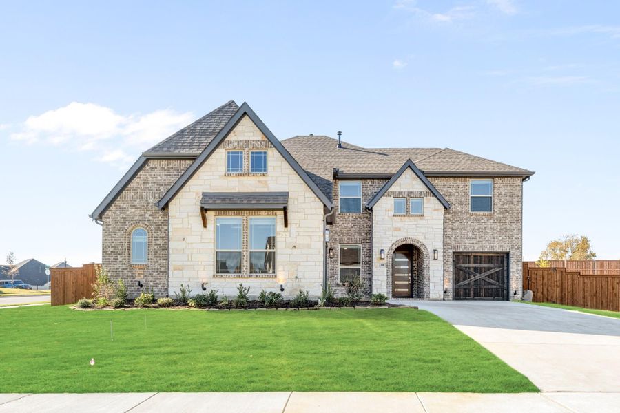 Two-story home with brick and stone exterior, arched entry, single-car garage, and manicured front lawn Two-story home with brick and stone exterior, arched entry, single-car garage, and manicured front lawn