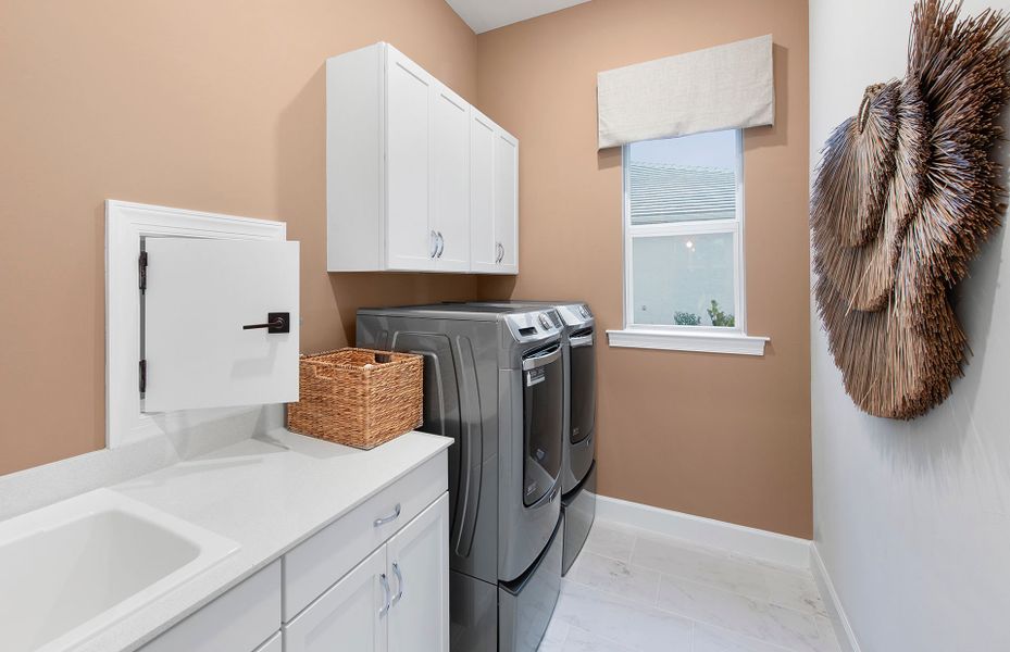 Laundry room with cabinets for extra storage