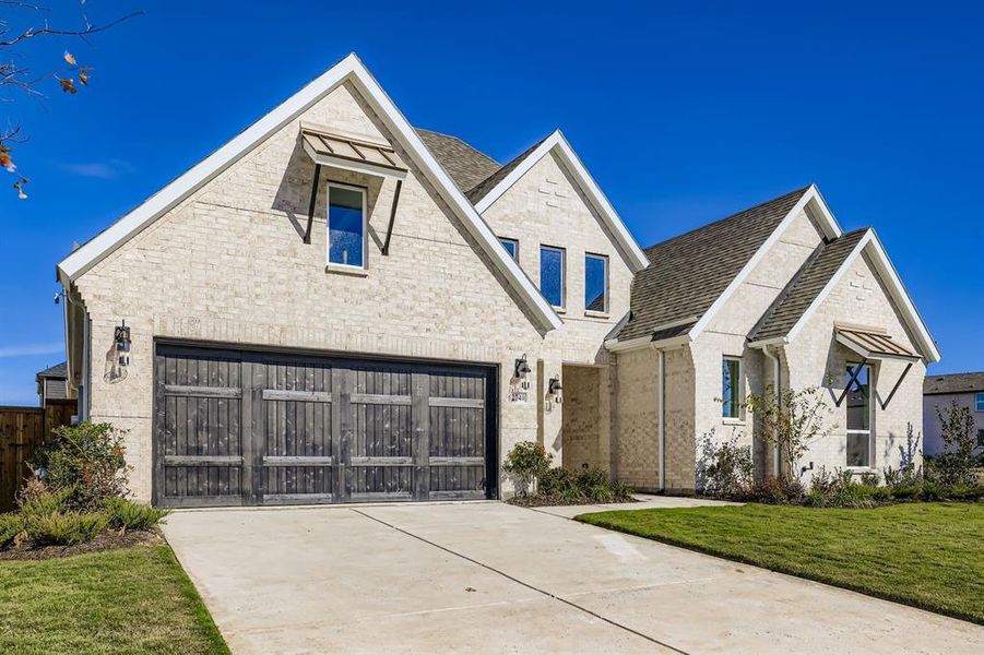 View of front of property with a garage, concrete driveway, brick siding, a front yard, and a shingled roof View of front of property with a garage, concrete driveway, brick siding, a front yard, and a shingled roof