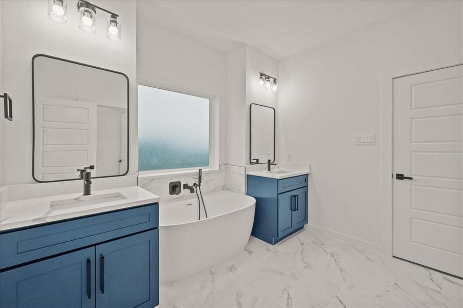 Bathroom with vanity and a bath