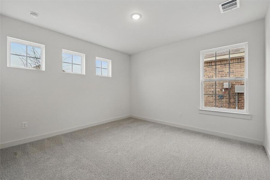 Unfurnished room with light carpet and baseboards Unfurnished room with light carpet and baseboards