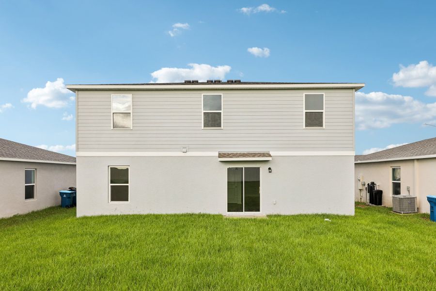 A white house with a green lawn. A white house with a green lawn.