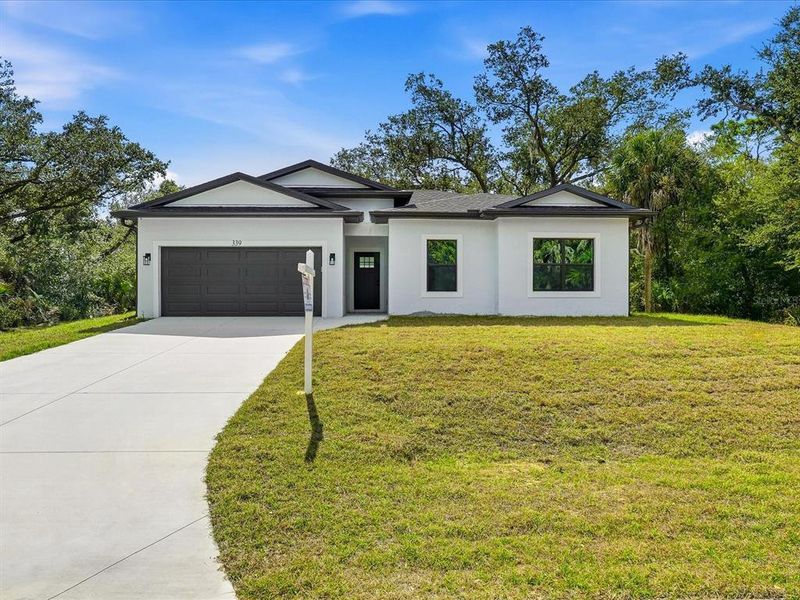 Front exterior of a new home in , Port Charlotte, FL, highlighting curb appeal (Image 16).