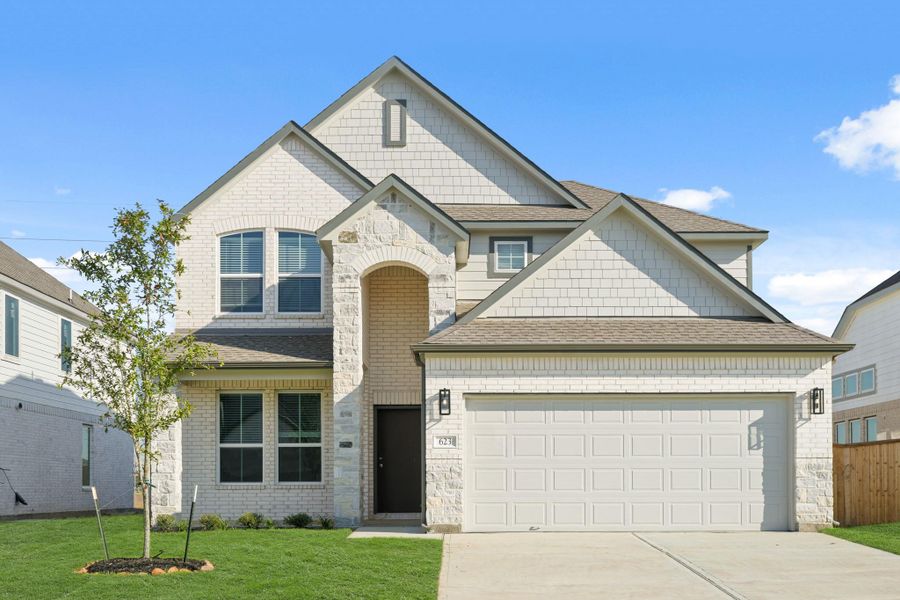 Front exterior of a new home in Huntington Place, Rosharon, TX, highlighting curb appeal (Image 1).