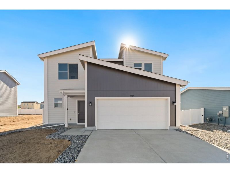Front exterior of a new home in Liberty Draw, Evans, CO, highlighting curb appeal (Image 1). Front exterior of a new home in Liberty Draw, Evans, CO, highlighting curb appeal (Image 1).