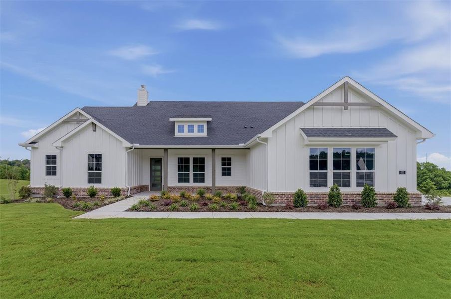 Modern farmhouse exterior featuring white board and batten siding, a dark shingle roof, a brick perimeter foundation, and a covered porch entry