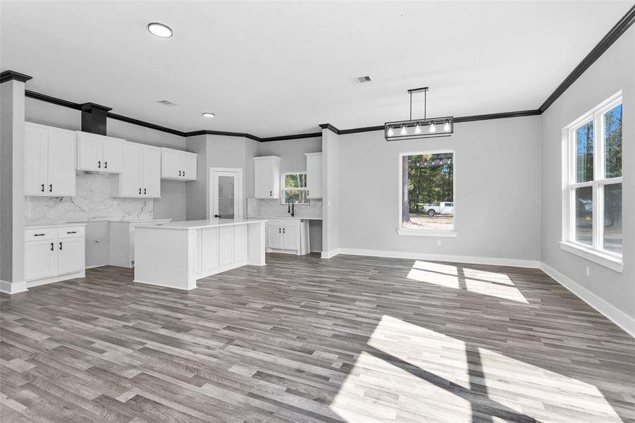 A view of Kitchen and dining area from living room. Look at all those windows allowing the outside in.