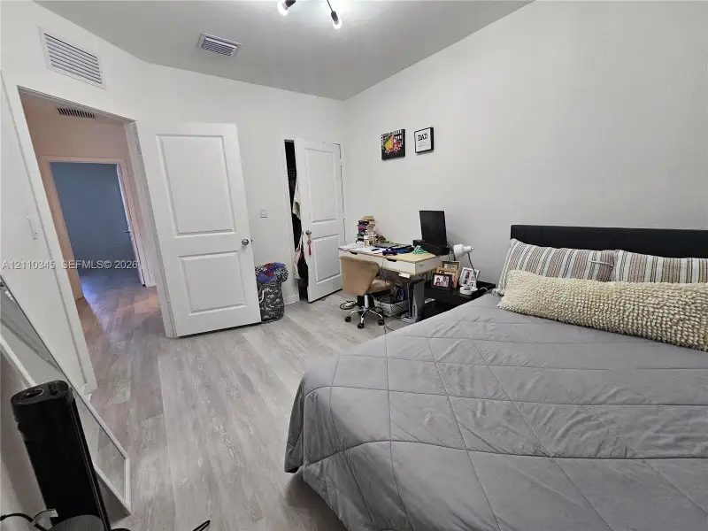 Interior space featuring wood-finish flooring, two-panel interior doors, and a built-in closet