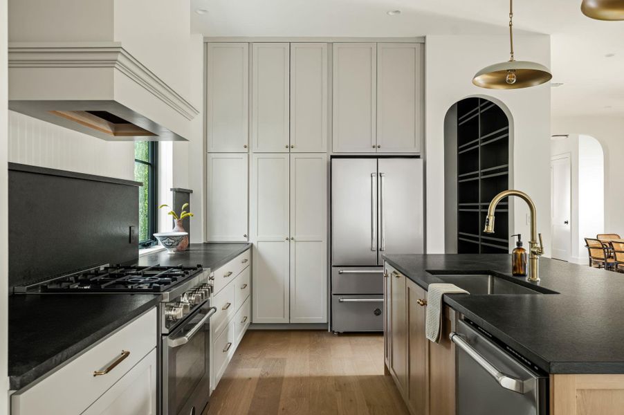 Culinary aspirations meet contemporary design in this naturally illuminated kitchen, complete with premium appliances.