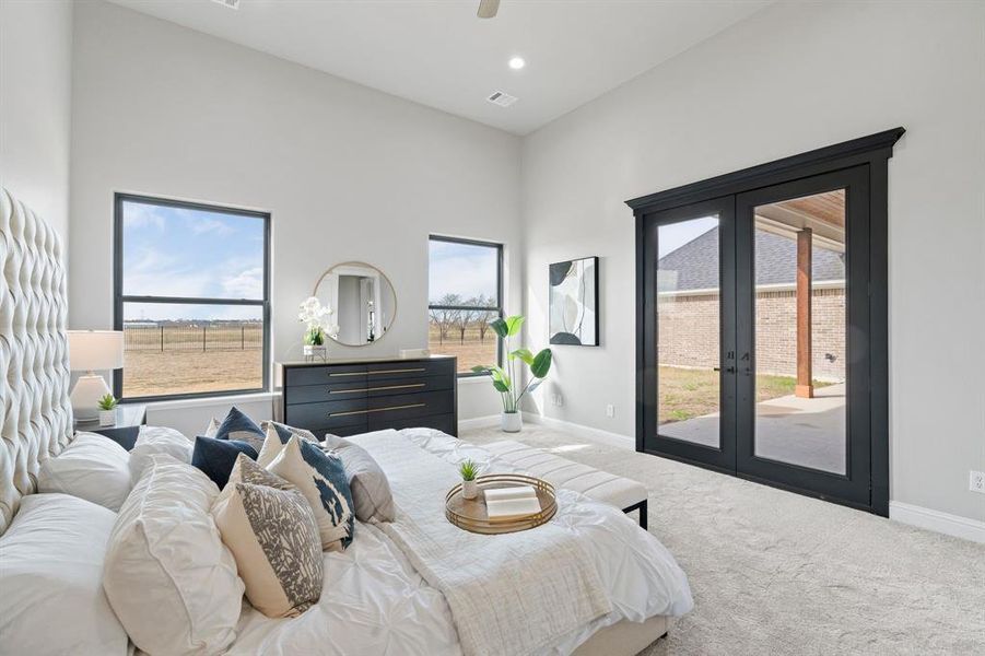 Carpeted bedroom featuring access to exterior and french doors