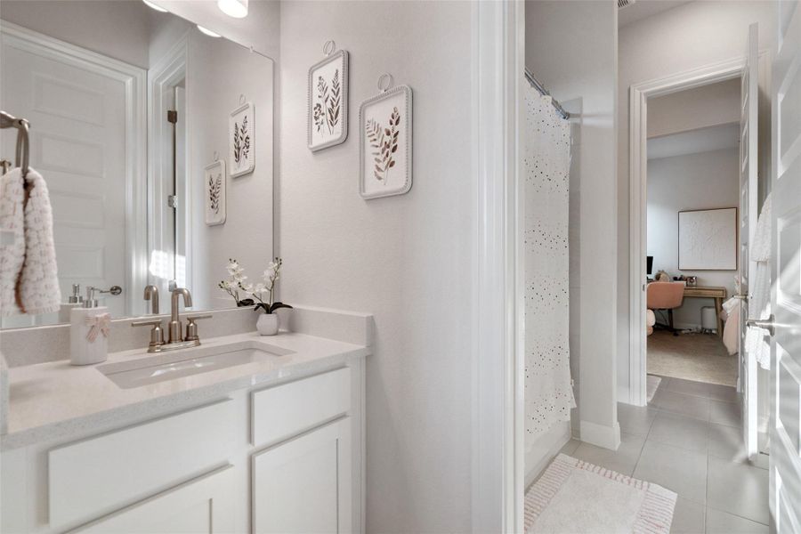 A pristine bathroom featuring a sleek vanity and convenient access to an adjacent room, perfect for daily routines. A pristine bathroom featuring a sleek vanity and convenient access to an adjacent room, perfect for daily routines.