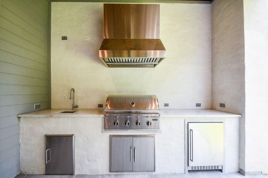 Outdoor Kitchen is custom made of Brick/Slurry, Cayote Appliance Package. 36" Grill, 24" Under Counter Fridge
