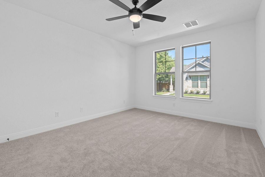 Spare room with light colored carpet and ceiling fan