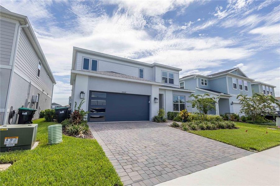 Front exterior of a new home in Parkview Reserve, Orlando, FL, highlighting curb appeal (Image 2). Front exterior of a new home in Parkview Reserve, Orlando, FL, highlighting curb appeal (Image 2).