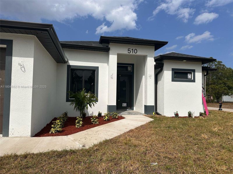 Front exterior of a new home in , Lehigh Acres, FL, highlighting curb appeal (Image 2). Front exterior of a new home in , Lehigh Acres, FL, highlighting curb appeal (Image 2).
