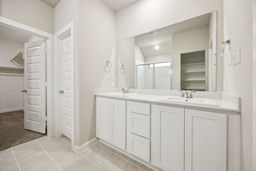 Primary Bathroom in the Oscar home plan by Trophy Signature Homes – REPRESENTATIVE PHOTO