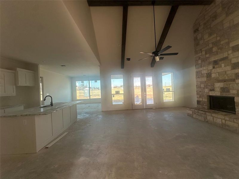 Large living with cathedral ceiling, stained beams and double back patio door Large living with cathedral ceiling, stained beams and double back patio door