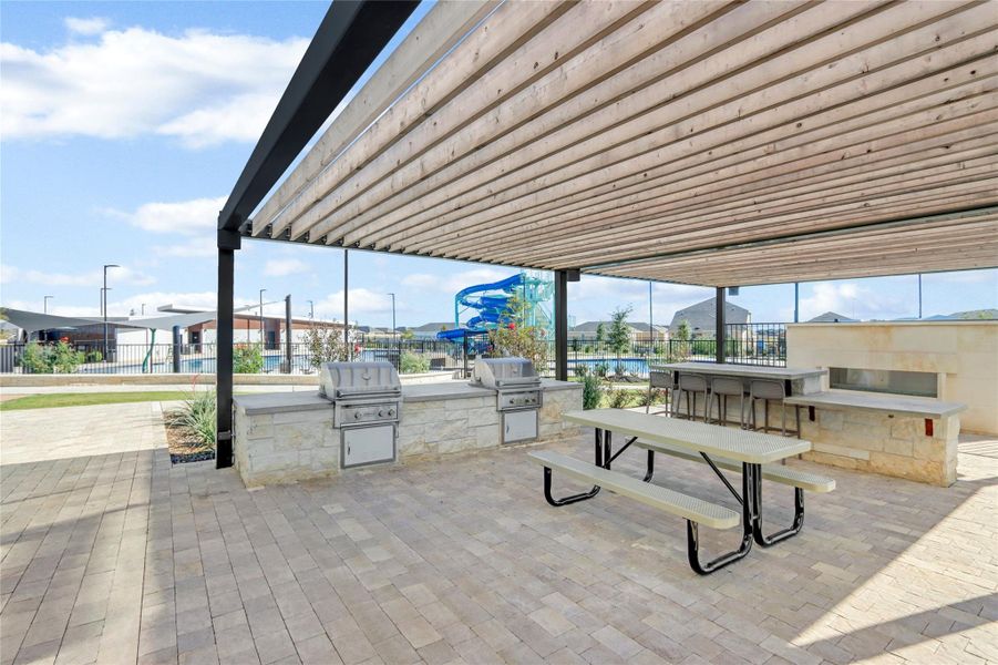 Surrounding community featuring exterior kitchen and a patio area