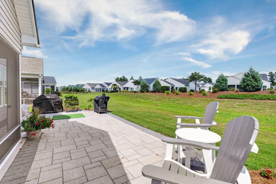 Exterior details and patio area of a home in K. Hovnanian's® Four Seasons at Lakes of Cane Bay, Summerville (Image 25).