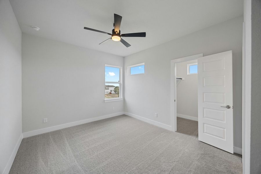 Spacious, unfurnished interior of a new home in Caliterra, Dripping Springs (Image 34).