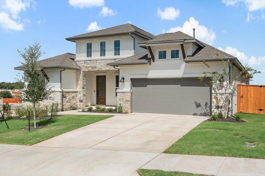 Front exterior of a new home in Lariat, Liberty Hill, TX, highlighting curb appeal (Image 21).