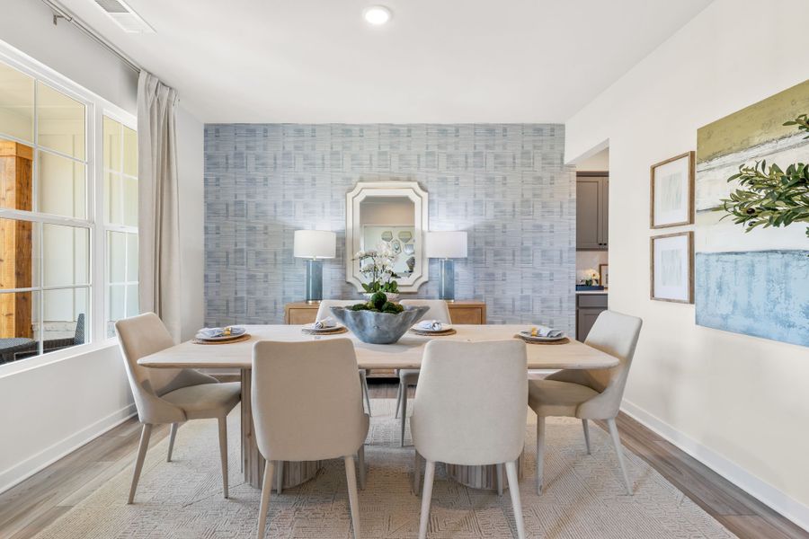 A dining room with a round table. A dining room with a round table.